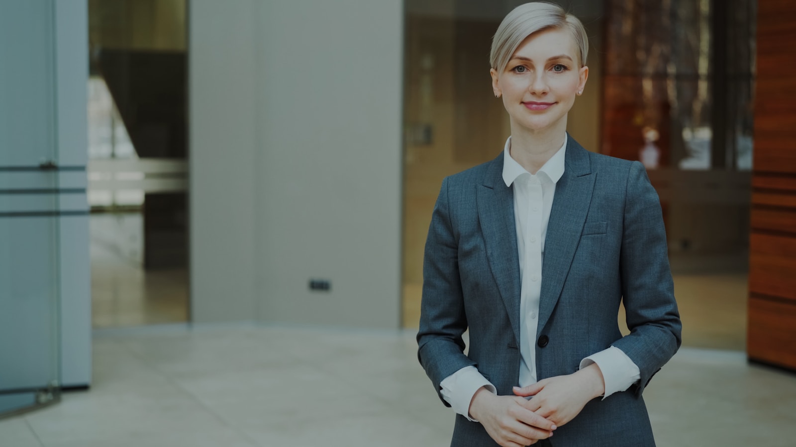 Executive portrait of Elena Voss in a modern corporate interior